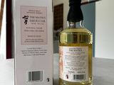 a bottle of olive oil next to a box on a table