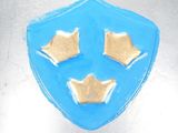 a blue and gold cake with three stars on it
