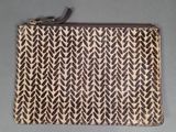 a brown and white clutch bag with a pattern on it