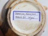 a label on the bottom of a vase that says american pottery