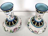 two vases that are sitting on a table