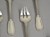several forks and spoons are lined up on a table