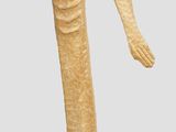 a statue of a woman standing on a wooden base