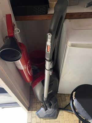 a vacuum that is sitting in the corner of a room
