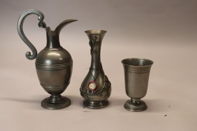 three silver vases sitting next to each other on a table