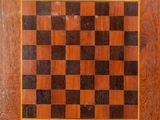a close up of a wooden chess board on a table
