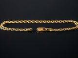 a gold chain bracelet with a clasp on a black background