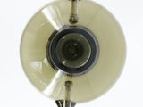 a glass vase with a camera on top of it