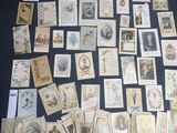 a lot of old postcards on a black table