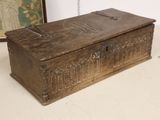 an old wooden box sitting on a table next to a framed picture