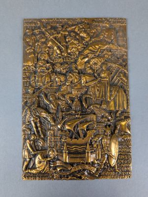 a gold plaque depicting a scene from the nativity of jesus