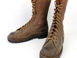 pair of brown leather boots with laces on them on a white background
