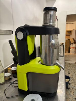 yellow and black blender sitting on top of a counter next to a roll of toilet paper