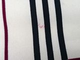 a close up of a black and white shirt with a red stripe
