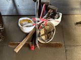 a pile of tools sitting on the floor next to a table