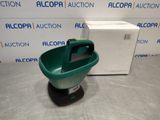 a close up of a green bucket on a table next to a box