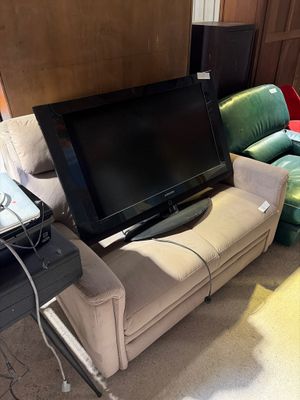 a television that is sitting on a couch in the living room
