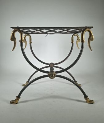 a black and gold console table with two horns on it