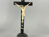 a black and gold crucif with jesus on the cross
