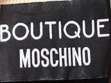 a label of a moschino brand on a black jacket
