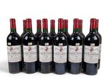 six bottles of red wine are lined up in a row