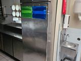 a stainless steel refrigerator in a commercial kitchen