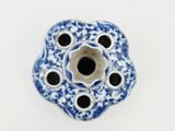 a blue and white vase with holes in it