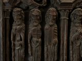a statue of a group of people standing in front of a building
