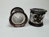 two glass vases sitting next to each other on a table