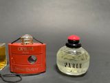 two perfume bottles sitting next to each other on a table