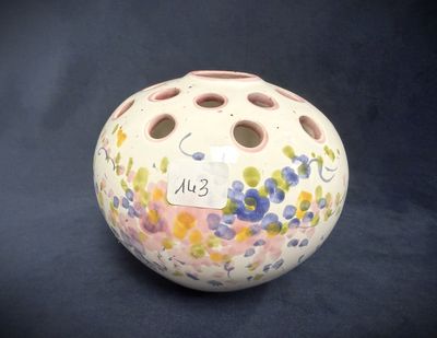 a small vase with a tag on it on a black background