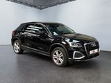 a black audi suv parked in a showroom with white walls