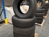 tires are stacked on pallets in a warehouse with pallets in the background