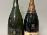 two bottles of champagne sitting next to each other on a table