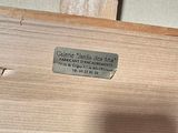 a picture of a close up of a piece of wood with a label on it