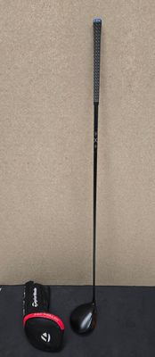 a close up of a golf club and a ball on a table