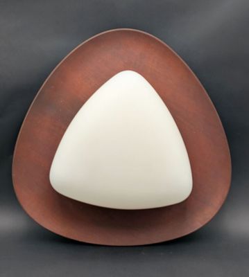 a white and brown triangle shaped object on a black background