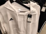 a white shirt hanging on a hanger in a store