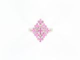 an image of a pink diamond ring sitting on top of a white surface