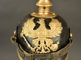 an old helmet with a golden eagle on the top of it