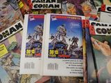 a lot of comic books that are on the table