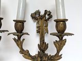 two candles that are on the wall next to each other