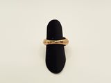 a close up of a gold ring on a black ring holder