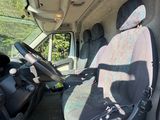 the interior of a van with two seats and a steering wheel