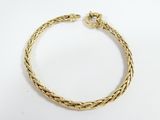 a gold bracelet with a braid design on a white background