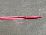 a red pen that is laying on a table