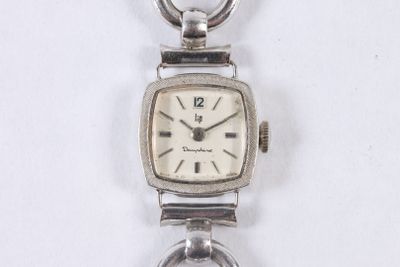 an image of a close up of a wrist watch on a chain