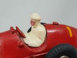 a red toy car with a man sitting in the driver ' s seat