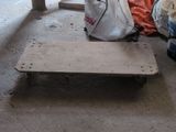 a wooden bench sitting in the middle of a room