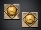 pair of gold and silver square earrings with a face on each side